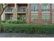 Stylish condo exterior featuring stone and brick accents, balconies, and lush landscaping at 840 United Ave # 113, Atlanta, GA 30312