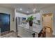 Modern kitchen with white cabinets, stainless steel appliances, a large island with seating and pendant lighting at 840 United Ave # 113, Atlanta, GA 30312