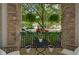 Stone porch decorated with fern planters and wrought iron table and chairs at 840 United Ave # 113, Atlanta, GA 30312