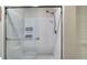 Tiled shower featuring a glass door, dual shelves, and modern fixtures at 840 United Ave # 113, Atlanta, GA 30312
