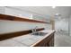 Basement wet bar featuring a tiled countertop and wood trim at 1460 Bakers Bridge Rd, Douglasville, GA 30134
