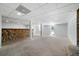 Unfinished basement featuring a unique river rock wall, columns, and a walkout door at 1460 Bakers Bridge Rd, Douglasville, GA 30134