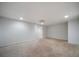 An open area in the basement with unfinished floors and white walls at 1460 Bakers Bridge Rd, Douglasville, GA 30134