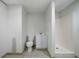 A simple basement bathroom with a toilet, vanity, and stand-up shower at 1460 Bakers Bridge Rd, Douglasville, GA 30134
