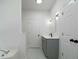 Bathroom featuring a soaking tub, tiled floors, modern vanity and custom lighting at 1460 Bakers Bridge Rd, Douglasville, GA 30134