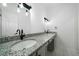 Bathroom features granite countertops, dual sinks, modern fixtures, and updated lighting at 1460 Bakers Bridge Rd, Douglasville, GA 30134