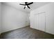 This bright bedroom features a ceiling fan, closet, and an open doorway at 1460 Bakers Bridge Rd, Douglasville, GA 30134