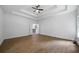 Spacious bedroom with tray ceiling, hardwood floors, and open layout at 1460 Bakers Bridge Rd, Douglasville, GA 30134