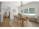Dining room with table and chairs, view of the living room and plenty of natural light at 1460 Bakers Bridge Rd, Douglasville, GA 30134
