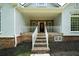 Inviting front porch with stone steps and white railings, leading to the home's entrance at 1460 Bakers Bridge Rd, Douglasville, GA 30134