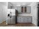 Eat-in kitchen with stainless steel fridge, granite counters, and gray cabinets at 1460 Bakers Bridge Rd, Douglasville, GA 30134