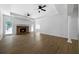 Bright living room featuring hardwood floors, a fireplace, ceiling fans and large windows at 1460 Bakers Bridge Rd, Douglasville, GA 30134