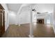 Open living room with hardwood floors, fireplace, white pillars and abundant natural light at 1460 Bakers Bridge Rd, Douglasville, GA 30134