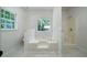 Bathroom featuring a large soaking tub, tiled floors and a walk-in shower at 1460 Bakers Bridge Rd, Douglasville, GA 30134