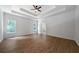 Spacious bedroom with tray ceiling, hardwood floors, and double windows at 1460 Bakers Bridge Rd, Douglasville, GA 30134