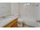Updated bathroom features a granite countertop, shower and tub combination, and wood-look flooring at 2690 Ross Rd, Snellville, GA 30039