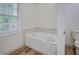 Bathroom features a large soaking tub and updated flooring at 2690 Ross Rd, Snellville, GA 30039