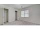 Bright bedroom featuring a closet, a window, and neutral carpeting at 2690 Ross Rd, Snellville, GA 30039