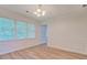 Bright dining room featuring wood floors, wainscoting, and large windows at 2690 Ross Rd, Snellville, GA 30039