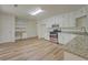 Bright kitchen features stainless steel appliances, granite countertops, and modern white cabinetry at 2690 Ross Rd, Snellville, GA 30039