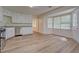 Bright kitchen features stainless steel appliances, granite countertops, and a breakfast nook with large windows at 2690 Ross Rd, Snellville, GA 30039