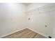 Laundry room with wood-look flooring, wire shelving, and convenient utility connections at 2690 Ross Rd, Snellville, GA 30039