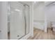 Bathroom features a stand up shower with glass door and updated flooring at 2690 Ross Rd, Snellville, GA 30039