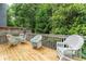 Charming deck featuring wicker furniture, a cozy seating arrangement, and views of lush greenery at 3745 Meeting St, Duluth, GA 30096