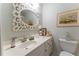 Bright bathroom with white vanity, decorative mirror, and lots of counter space for toiletries at 3745 Meeting St, Duluth, GA 30096