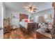 Charming bedroom featuring hardwood floors, ceiling fan, and ornate dark wood furniture set at 3745 Meeting St, Duluth, GA 30096