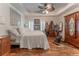 Spacious bedroom with hardwood floors, large bed, ceiling fan, and adjacent exercise area at 3745 Meeting St, Duluth, GA 30096