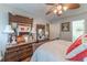 Bedroom with hardwood floors, ceiling fan, and ornate dark wood furniture set and bright decor at 3745 Meeting St, Duluth, GA 30096