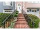Charming brick staircase leading to the front door, complemented by manicured greenery and potted plants at 3745 Meeting St, Duluth, GA 30096