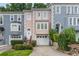 Charming townhomes in a row with colorful facades, driveways, and well-maintained landscaping at 3745 Meeting St, Duluth, GA 30096