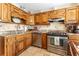 Well-appointed kitchen featuring wood cabinets, granite countertops, and stainless steel appliances at 3745 Meeting St, Duluth, GA 30096