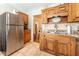 Spacious kitchen featuring a stainless steel refrigerator, wooden cabinets, and granite countertops at 3745 Meeting St, Duluth, GA 30096
