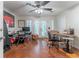 Spacious home office featuring french doors, natural light, ceiling fan, and desk and chair setup at 3745 Meeting St, Duluth, GA 30096