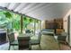 Covered patio space with dining set, lounge seating, and peaceful backyard views at 3745 Meeting St, Duluth, GA 30096