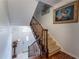 Open staircase featuring hardwood floors and a white front door allowing lots of natural light at 3745 Meeting St, Duluth, GA 30096