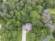 Aerial view showcases a home with a long driveway, surrounded by mature trees and lush landscaping at 41 Wexford Nw Cir, Cartersville, GA 30121