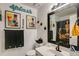 Decorated bathroom with artwork and a large mirror, along with a sink and toilet at 41 Wexford Nw Cir, Cartersville, GA 30121