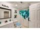 Bright bathroom featuring a vanity sink, toilet, and shower with updated fixtures and peacock-themed decor at 41 Wexford Nw Cir, Cartersville, GA 30121