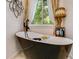 Stylish bathroom showcasing a modern standalone tub next to a window and decorative curtains at 41 Wexford Nw Cir, Cartersville, GA 30121