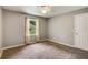 Neutral bedroom with plush carpet, ceiling fan, and natural light from the window overlooking the outdoors at 41 Wexford Nw Cir, Cartersville, GA 30121