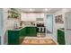Modern kitchen featuring green cabinetry, a stainless steel oven, and a stylish backsplash at 41 Wexford Nw Cir, Cartersville, GA 30121