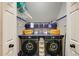 Organized laundry room with washer, dryer, folding area and overhead shelving units at 41 Wexford Nw Cir, Cartersville, GA 30121