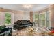 Cozy living room featuring a plush leather couch, decorative rug, and ample natural light at 41 Wexford Nw Cir, Cartersville, GA 30121