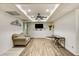 Spacious living room with stylish wood floors, a ceiling fan, and a modern wall-mounted television at 41 Wexford Nw Cir, Cartersville, GA 30121