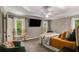 Bright main bedroom with hardwood floors, a ceiling fan and large windows offering a wooded view at 41 Wexford Nw Cir, Cartersville, GA 30121