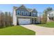 Charming two-story home with light blue siding, white trim, and a well-manicured lawn at 109 Laurelwood Ln, Dallas, GA 30157